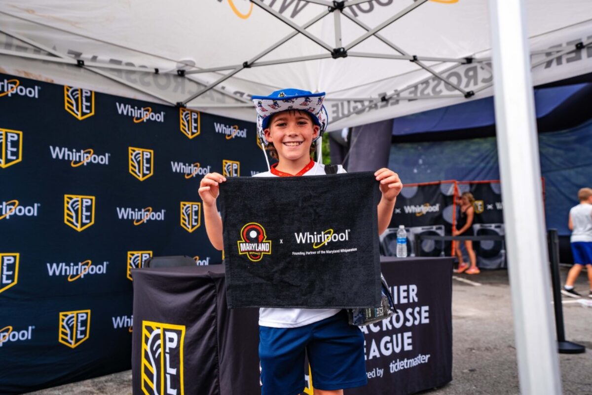 Kid holding a Whirlpool logo towel