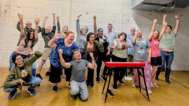 People posing with hands up