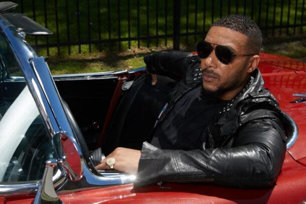 Lyfe Jennings in a red car