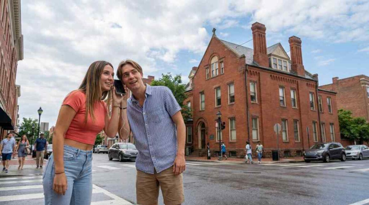 2 people listening to a phone