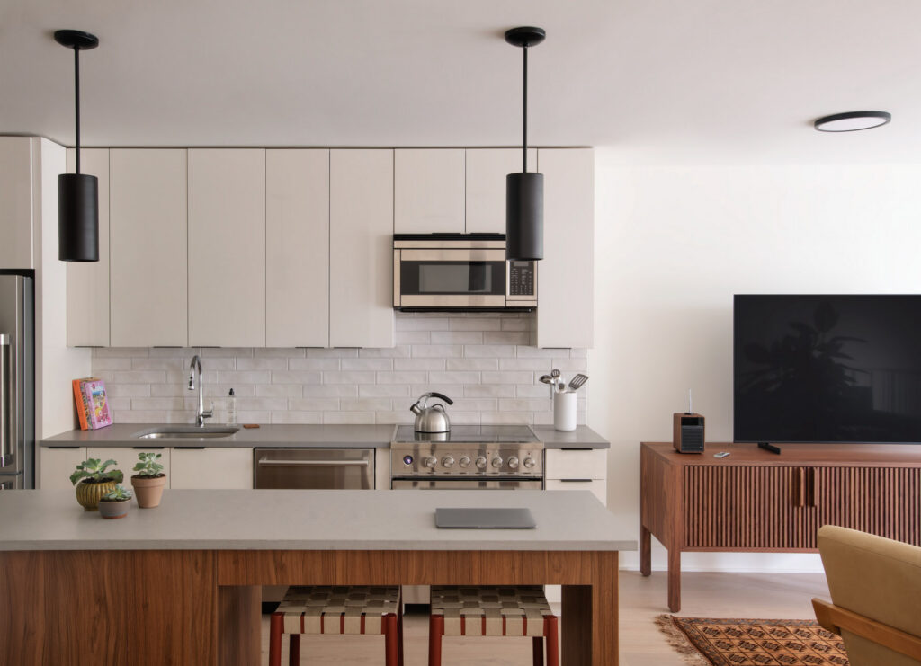 Interior shot of a kitchen and living room in a room at the apartment-style ROOST hotel