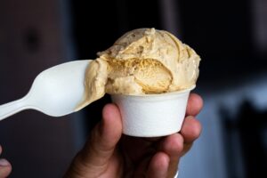 close-up shot of honey graham ice cream in a cup with a spoon